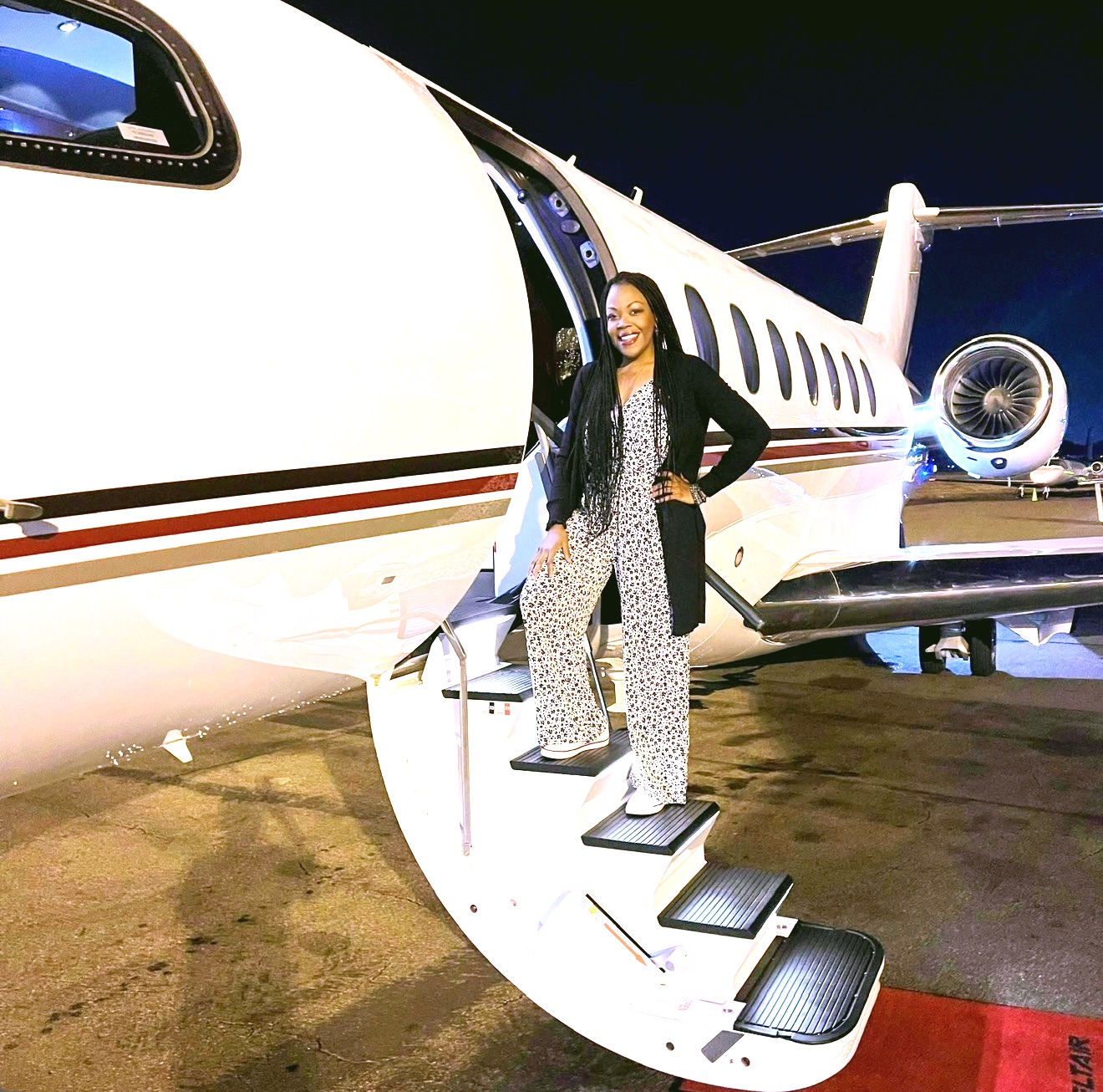 Kandace Friend standing on the steps of a private aircraft
